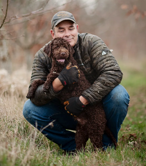 Peter Brietzke holding a lagotto romagnolo truffle hunting puppy